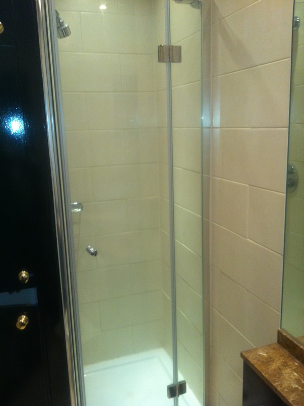 Frameless glass shower enclosure with chrome fittings in Hayes
