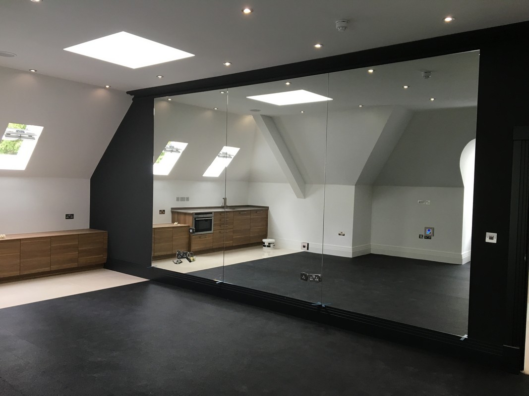 Frameless glass wall dividing loft conversion in Hayes