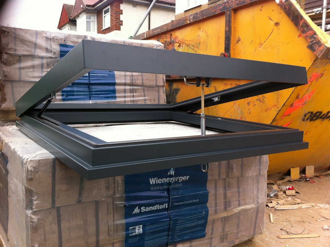 Opening flat roof skylight in anthracite grey installed in Hayes