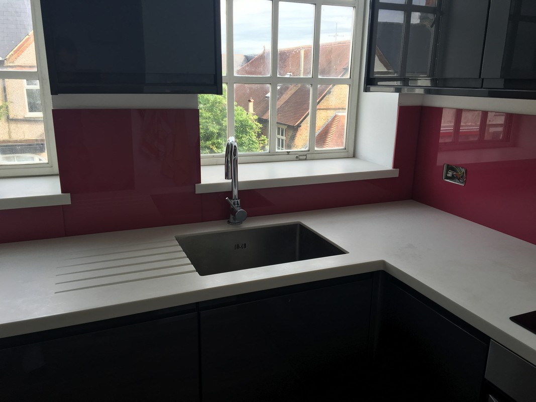 Deep plum coloured glass splashback in modern Hayes kitchen